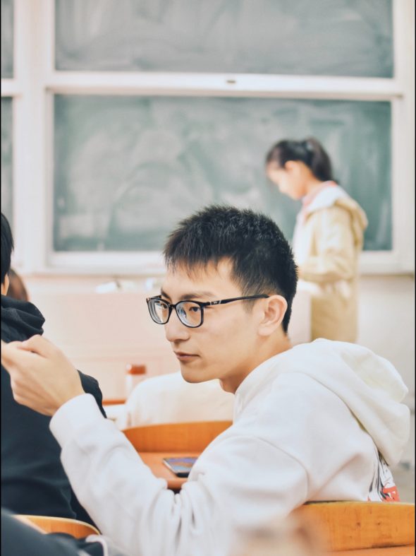 people sitting and standing inside classroom