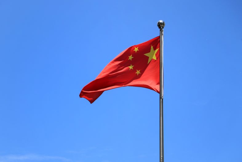 red and white flag under blue sky during daytime